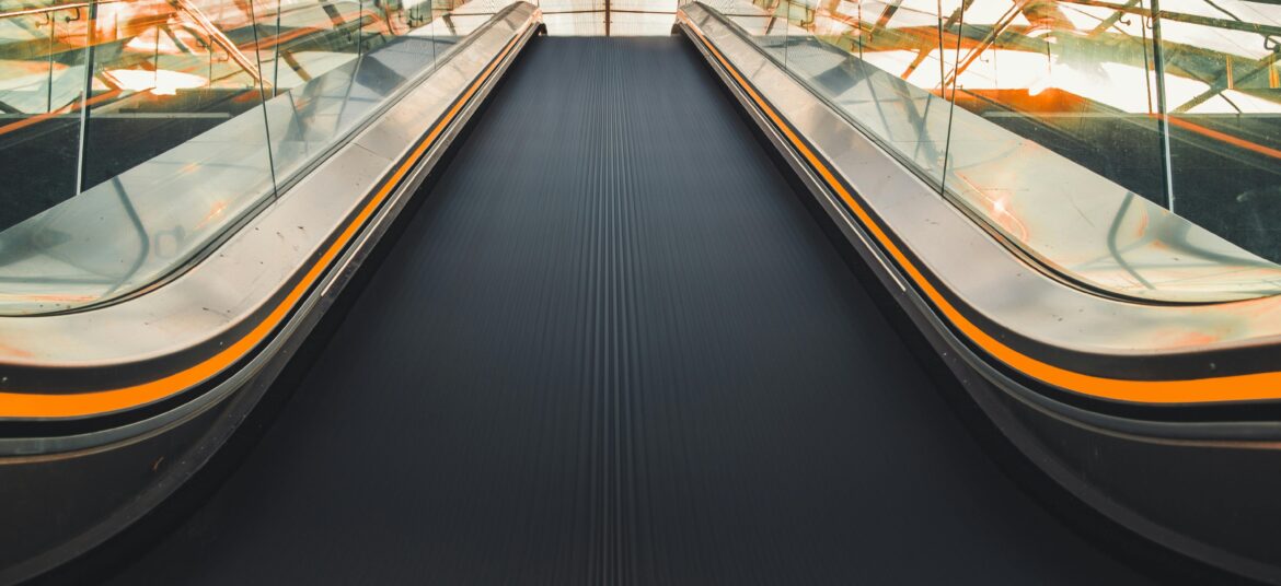 Dynamic low angle view of an escalator in a Hamburg transport hub, showcasing modern design and perspective.